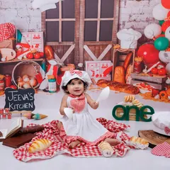 A full view of our 'Little Chef' setup, with breads, balloons, and a personalized sign. This little girl is having a great time in her own kitchen.