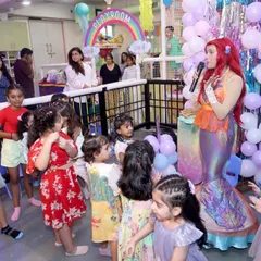 The look of pure wonder on a child's face is what we live for. Here, a group of young guests are completely captivated as they meet and interact with our beautiful mermaid character during a themed party.