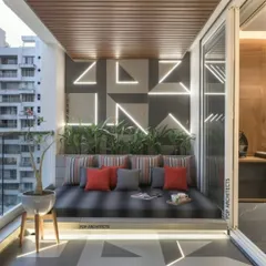 A modern balcony designed for lounging. This space features a large, built-in daybed with plush cushions. The geometric patterns on the wall and floor are highlighted with integrated LED strip lighting for a futuristic look.