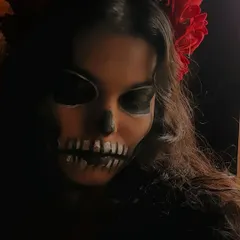 In low light, the Calavera Catrina makeup takes on an even more haunting and dramatic quality. I love playing with lighting in photoshoots to enhance the mood of the styling.