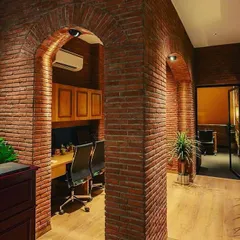 For this office at Sushma Buildtech, the goal was a warm and classic feel. I used focused downlights within the brick arches to create pools of light over workstations, combining the industrial texture of the brick with a comfortable, focused work environment.
