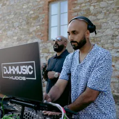 Another shot of me DJing in Tuscany with my Kudos DJ partner. We're getting set up for an outdoor party, ready to blend our sound with the beautiful Italian landscape.