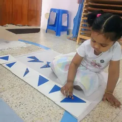 The Geometrical Cabinet is a sensorial introduction to plane geometry. As this child traces and places the shapes, she is learning their names and refining her visual discrimination skills, laying a solid foundation for future math.