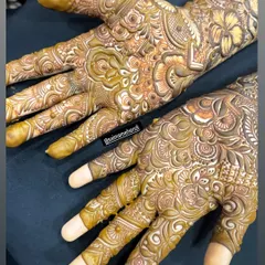 A stunning close-up of a full-hand design, showcasing the white-toned highlights that some artists use to make the pattern pop for photos before the paste is removed.