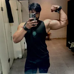 Showing off arm size and definition with wrist wraps on after a tough workout.