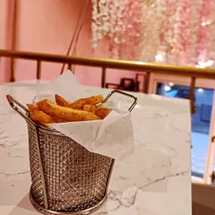 A basket of our crispy peri peri fries, perfectly seasoned for a spicy kick. This is a popular snack to enjoy any time of day at the cafe.