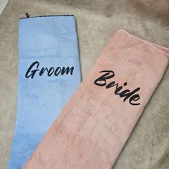 An unfolded view of the personalized "Bride" and "Groom" towels, showing their full size.