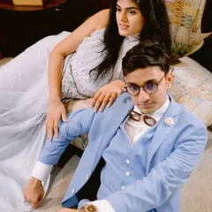 A cool, confident portrait with a touch of quirkiness. His unique glasses and their relaxed yet styled poses give this shot a distinct, modern-vintage vibe.