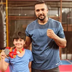 A young champion from my team, proudly showing off his medal. Hard work pays off at any age.