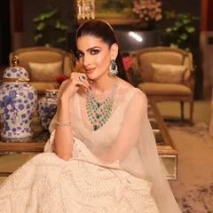 A seated portrait that captures the grace and poise of the modern bride, with makeup that enhances her natural beauty.