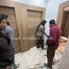 During a site visit, we inspect every detail. Here, we are checking the finish and alignment of newly installed wooden wardrobe doors, ensuring they meet our quality standards.