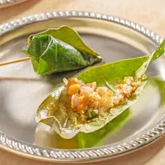 A traditional mouth freshener, served with elegance. We offer beautifully prepared paan, a betel leaf parcel filled with sweet and aromatic ingredients, as a perfect end to a grand Indian meal.