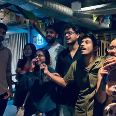 It's not about being a pro, it's about the shared energy. Here, a group of friends take the stage together, turning a regular night into a core memory.