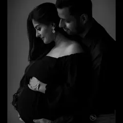 A close-up, artistic black and white portrait that captures the tenderness between partners. These are the quiet, intimate moments that become the most cherished memories of your pregnancy.