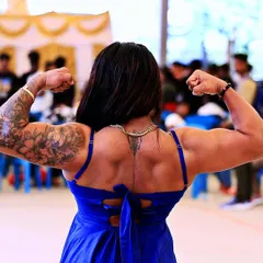 Bulking time. A powerful back double bicep pose during my off-season. This phase is crucial for adding the size that will later be refined into a winning physique.