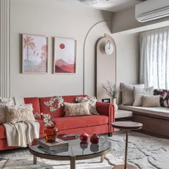 A pop of color can bring so much joy to a room. In this living space, a bold red sofa is balanced by a neutral beige palette, creating a look that is both vibrant and inviting.