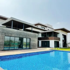 A wide view of a recently completed swimming pool for a modern residence. Our construction process ensures seamless integration with the property's architecture, creating a clean, expansive outdoor oasis perfect for relaxation and entertainment.