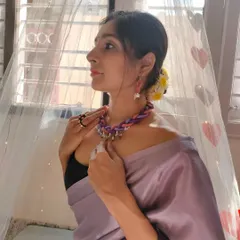 Here I am modeling the braided thread necklace, showing how it can elevate a simple saree. The combination of colors and textures makes it a versatile accessory.