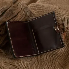 The inside of a handmade bifold leather wallet, showing the card slots and clean stitching. Participants learn to design and construct practical items like this from start to finish.