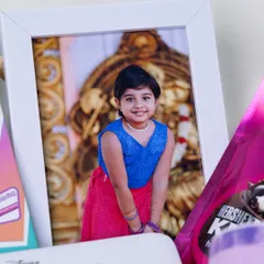 A framed photo of the birthday girl is the centerpiece of this personalized hamper, making the gift all about her.