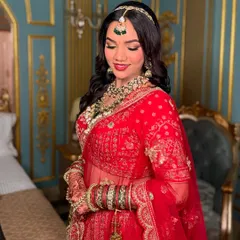 A moment of quiet reflection for the bride. The makeup is set to look flawless from every angle, capturing the emotion of the day.