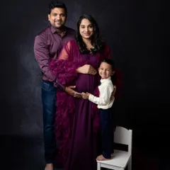 A complete family portrait during a maternity session. The older brother joins his parents, creating a beautiful image of the family as they wait to welcome their newest member.
