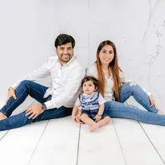 A relaxed family photo where everyone is comfortable and connected. The matching denim and white shirts create a cohesive and casual vibe.