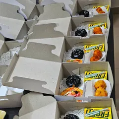 A batch of customized snack boxes ready for delivery. Each box is carefully packed to ensure the food stays fresh and looks appealing.