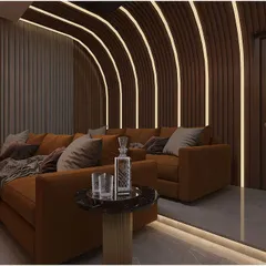 A concept for a dedicated home theater, featuring plush seating and curved, backlit wall panels for an immersive cinematic experience.