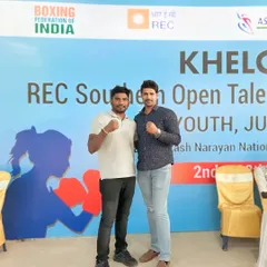 Posing with a friend at a Boxing Federation of India event. I stay connected to the sport to bring the best techniques to my students.