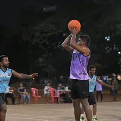 A player rises for a jump shot over the defense. Capturing the skill and athleticism on display at our men's league games.