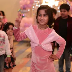 Striking a pose during a party. This little girl's confidence and happiness are what our celebrations are all about.
