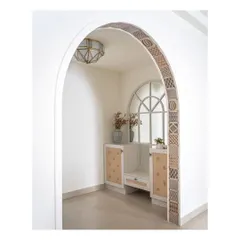 The grand arch at the entrance of the home, covered with charming patterned tiles. This newly built arch cleverly separates the foyer while providing a welcoming glimpse into the living room.