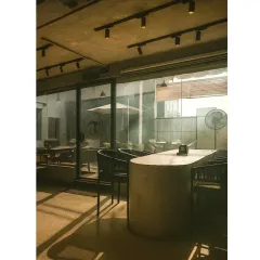 We designed this cafe to have a strong connection between the indoor and outdoor spaces. Large glass panels allow for an abundance of natural light and a view of the patio, making the interior feel open and airy.