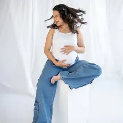 A moment of pure, carefree happiness. I love capturing these unposed shots, like a happy hair flip, that show the joyful spirit of the mom-to-be.