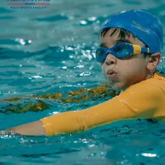 Focused and determined, this young swimmer practices his breathing technique during a lesson. We build skills step by step to ensure confidence in the water.