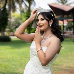 Capturing the pure joy of a bride-to-be. This classic white Christian bridal gown features beautiful subtle embroidery and a timeless silhouette. Paired with one of my sparkling tiaras, it creates an ethereal and unforgettable wedding day look.