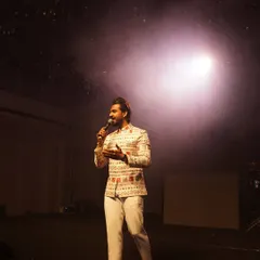 Under the spotlight, I'm not just an MC, I'm a storyteller for your big night. This shot from a Sangeet in Udaipur captures the essence of my role: holding the audience's attention and weaving together performances and moments into a seamless, entertaining show.