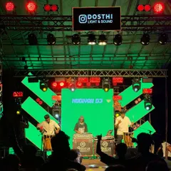 A look at my Kerala fusion setup in action. I'm at the DJ console, flanked by two talented Chenda players, creating a powerful mix of electronic and traditional beats under a full LED light show.