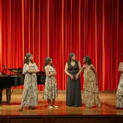 On stage performing with my friends for our graduation concert. This shows my experience in ensemble singing and performing in a formal concert setting.
