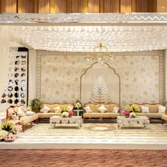 An elegant lounge seating area designed with a neutral color palette, intricate backdrops, and classic furniture. This space provided a comfortable and sophisticated retreat for guests during the festivities.