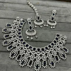 A closer look at the blue and white stone necklace set. The intricate design gives it a rich, heavy look, perfect for a bride's reception or a sangeet night.