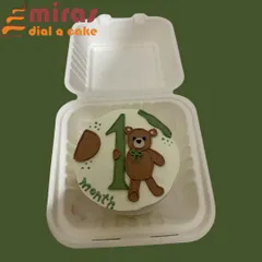 A sweet way to celebrate a baby's first month. This bento cake is decorated with a cute teddy bear and the number "1," using soft, neutral colors perfect for a milestone celebration.