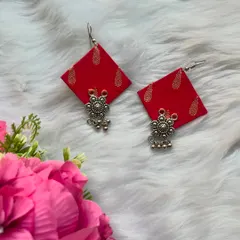 A beautiful handmade fabric earring in a vibrant red. The fabric has a gold block print, and I've added a simple oxidised floral charm to complete the look.