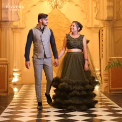 A beautiful shot of a couple during their pre-wedding shoot. He is wearing a modern grey vest and trouser set, a great option for a more relaxed yet stylish formal look.