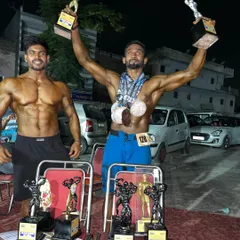 Results speak louder than words. Here is my student celebrating his win after months of brutal discipline and training. We don't just train to look good; we train to be champions on stage.
