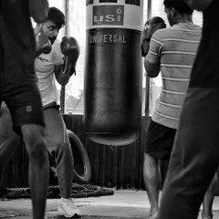 A group of fighters working around the heavy bag. This drill helps with movement, timing, and finding your range.