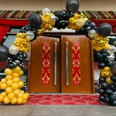I can create a grand entrance for your event with a custom balloon arch. This one uses a bold black and yellow color scheme to welcome guests to a party, setting a celebratory tone right from the door.