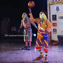 Step right up for a circus of laughs! Our clowns are masters of physical comedy and skill, seen here performing a classic ball balancing trick that keeps the audience captivated and entertained.