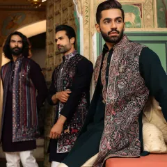 We create complementary looks for the entire wedding party. This photo showcases a range of our festive wear, featuring intricately embroidered Nehru jackets over dark-toned kurtas, perfect for a coordinated yet individual style.